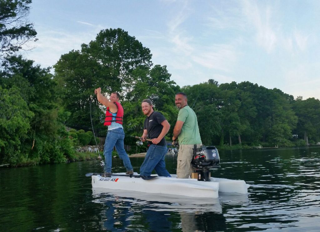 A micro skiff with three anglesr standing and fishing